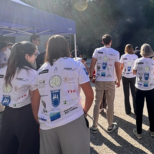 Partecipante con maglietta rossa personalizzata dell'evento durante una simulazione con visore VR